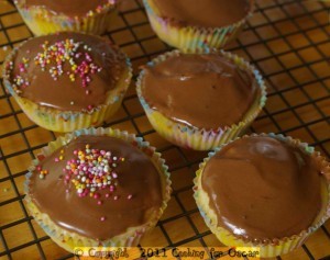 Cup cakes with carob icing and naturally coloured 100s and 1000s.