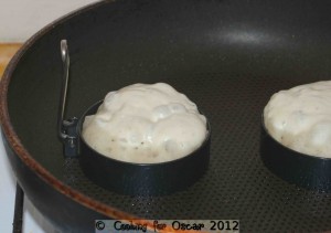 Pouring the crumpet batter into the egg rings